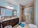 Updated bathroom featuring granite countertop, large mirror, and tiled shower with glass doors at 7060 Summit Ridge Chase, Cumming, GA 30041