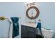 Charming half bathroom features a bronze mirror and towel rack at 7060 Summit Ridge Chase, Cumming, GA 30041