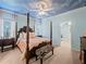 Comfortable bedroom with a four-poster bed, sky-painted ceiling, and zebra-print bench at 7060 Summit Ridge Chase, Cumming, GA 30041