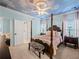 Charming bedroom featuring a four-poster bed, sky-painted ceiling, and zebra-print bench at 7060 Summit Ridge Chase, Cumming, GA 30041