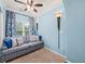 This charming room features a ceiling fan, comfortable couch, and blue accents at 7060 Summit Ridge Chase, Cumming, GA 30041