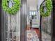 A grand foyer featuring an ornate entry door, elegant staircase, and a decorative rug at 7060 Summit Ridge Chase, Cumming, GA 30041
