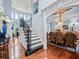 Bright foyer with hardwood floors and staircase adjoins the formal dining room at 7060 Summit Ridge Chase, Cumming, GA 30041