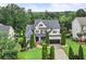 A stunning two-story brick home showcasing lush landscaping and a spacious driveway at 7060 Summit Ridge Chase, Cumming, GA 30041