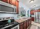 Well-equipped kitchen featuring stainless steel appliances, granite countertops, and ample cherry cabinetry at 7060 Summit Ridge Chase, Cumming, GA 30041