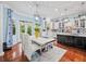 Bright kitchen with white cabinetry and a marble countertop table with seating and backyard access at 7060 Summit Ridge Chase, Cumming, GA 30041