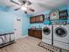Spacious laundry room with modern washer and dryer units, and ample storage space at 7060 Summit Ridge Chase, Cumming, GA 30041