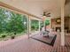 Covered brick patio with outdoor fireplace, ceiling fan and nice view at 7060 Summit Ridge Chase, Cumming, GA 30041