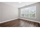 Cozy bedroom with neutral paint, hardwood floors, and a large window at 840 United Avenue Southeast # 401, Atlanta, GA 30312