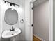 Modern half bath with sleek pedestal sink, contemporary lighting, and stylish fixtures at 89 Prospect Path, Hiram, GA 30141