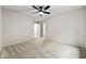 Carpeted bedroom with neutral walls showcases access to multiple doors and ample space at 89 Prospect Path, Hiram, GA 30141