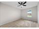 Well-lit bedroom featuring neutral walls, plush carpeting, and a ceiling fan at 89 Prospect Path, Hiram, GA 30141