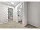 Hallway with neutral carpet leads to a bedroom and bathroom, providing a cohesive and functional layout at 89 Prospect Path, Hiram, GA 30141