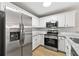 Modern kitchen with stainless steel appliances, granite counters, and subway tile backsplash at 89 Prospect Path, Hiram, GA 30141