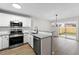 Updated kitchen featuring granite countertops, stainless appliances, and a view to the backyard at 89 Prospect Path, Hiram, GA 30141