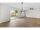 Bright living room with sliding glass doors to the backyard, modern lighting, and open floor plan at 89 Prospect Path, Hiram, GA 30141
