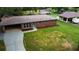 Aerial view of home showing well-manicured yard, brick exterior, carport, and new landscaping at 191 Pine Ne St, Fairburn, GA 30213
