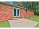Brick home exterior with blue double doors leading to a concrete patio and backyard at 191 Pine Ne St, Fairburn, GA 30213