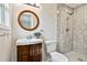 Updated bathroom features a vanity with round mirror and tiled walk-in shower at 191 Pine Ne St, Fairburn, GA 30213