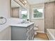 Updated bathroom with marble countertop vanity, and tiled shower at 191 Pine Ne St, Fairburn, GA 30213