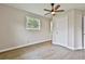 Bright bedroom featuring a ceiling fan, window, closet, and wood-look flooring at 191 Pine Ne St, Fairburn, GA 30213