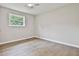 Bedroom with wood-look flooring, ceiling fan, and large window at 191 Pine Ne St, Fairburn, GA 30213