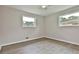 Bright bedroom featuring a ceiling fan, two windows, and wood-look flooring at 191 Pine Ne St, Fairburn, GA 30213