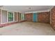 Attached brick carport featuring a door and large windows at 191 Pine Ne St, Fairburn, GA 30213