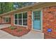 View of the front door and entry, highlighting the home's brick exterior and landscaping at 191 Pine Ne St, Fairburn, GA 30213