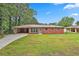 Charming single-story brick home with a spacious front yard and attached carport at 191 Pine Ne St, Fairburn, GA 30213