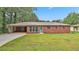 Charming single-story brick home with a spacious front yard and attached carport at 191 Pine Ne St, Fairburn, GA 30213