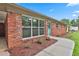 Close-up view of the brick exterior, blue front door, and landscaped entrance at 191 Pine Ne St, Fairburn, GA 30213