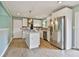 Updated kitchen featuring stainless steel appliances, a central island, and a modern backsplash at 191 Pine Ne St, Fairburn, GA 30213