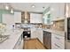 Close up of a modern kitchen featuring stainless steel appliances, a stove, and quartz countertops at 191 Pine Ne St, Fairburn, GA 30213