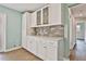 Charming kitchen area with white cabinetry, countertop, and brick backsplash at 191 Pine Ne St, Fairburn, GA 30213