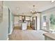 Bright, open kitchen with a stainless steel fridge, island, and sliding door access to the backyard at 191 Pine Ne St, Fairburn, GA 30213
