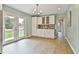 Open-concept kitchen with backyard access, showcasing white cabinets and generous counter space at 191 Pine Ne St, Fairburn, GA 30213