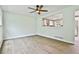 Well-lit living room with a ceiling fan showcases wood floors and an open design to the kitchen at 191 Pine Ne St, Fairburn, GA 30213