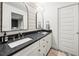 Bathroom featuring a double vanity, granite countertop, shiplap walls, and a modern design at 2020 New Kemp Rd, Marietta, GA 30066