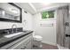 Modern bathroom featuring granite countertop vanity and shower with gray wood-look tile at 2020 New Kemp Rd, Marietta, GA 30066