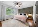 Cozy bedroom with a king-size bed, hardwood floors, decorative wallpaper and natural light from a large window at 2020 New Kemp Rd, Marietta, GA 30066