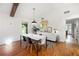 Dining room featuring a modern table set, stylish decor, hardwood floors, and access to other rooms at 2020 New Kemp Rd, Marietta, GA 30066