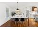 Dining room featuring a modern table set, stylish decor, hardwood floors, and an open view to the kitchen at 2020 New Kemp Rd, Marietta, GA 30066