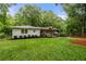 Beautiful single story home featuring a well-manicured lawn and charming curb appeal surrounded by mature trees at 2020 New Kemp Rd, Marietta, GA 30066