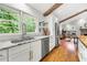 Modern kitchen with white cabinets, granite countertops, stainless steel appliances, and hardwood floors with natural light at 2020 New Kemp Rd, Marietta, GA 30066