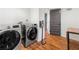 Modern laundry room featuring Samsung washer and dryer and hardwood floors at 2020 New Kemp Rd, Marietta, GA 30066