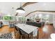 Open-concept living space featuring a modern kitchen, dining area with sleek furniture, and a cozy living room with a fireplace at 2020 New Kemp Rd, Marietta, GA 30066