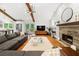 Spacious living room with vaulted ceilings, hardwood floors, fireplace, and gray sectional sofa, seamlessly connecting to the kitchen at 2020 New Kemp Rd, Marietta, GA 30066