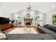Open living room with vaulted ceilings, hardwood floors, fireplace, and large gray sectional sofa, flooded with natural light at 2020 New Kemp Rd, Marietta, GA 30066