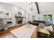 Bright living room featuring hardwood floors, a stone fireplace, vaulted ceiling, and a comfortable gray sectional at 2020 New Kemp Rd, Marietta, GA 30066